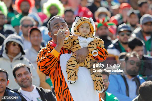 Bangladesh father and son fans, dressed in tiger costumes and holding a toy kangaroo, during the Australia v Bangladesh ICC Cricket World Cup match...