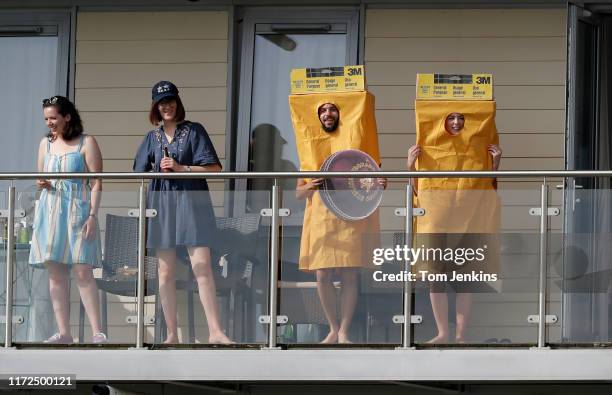 On the balcony of a flat overlooking the ground, a couple dressed up as a sandpaper poking fun at the Australian players during the Afghanistan v...