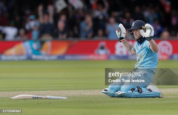 Ben Stokes of England apologises after he dives to make his ground but the ball deflects off his bat for four overthrows during the England v New...