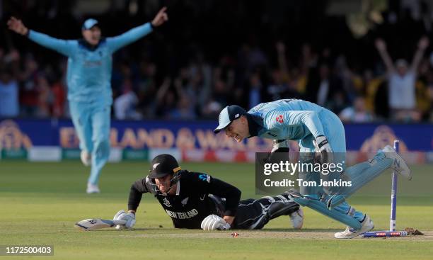 Jos Buttler runs out Martin Guptill off the final ball of the superover to give England victory during the England v New Zealand ICC Cricket World...