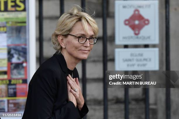 France's former President Jacques Chirac's daughter Claude Chirac thanks members of the public as she arrives to attend a church service for former...