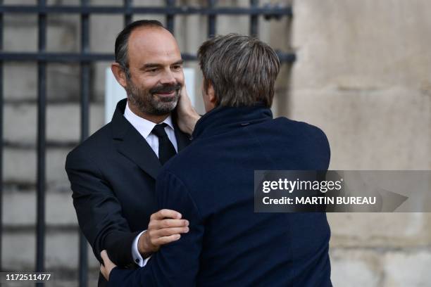 The President of the France's Mayors Organization Francois Baroin is greeted by France's Prime Minister Edouard Philippe as he arrives to attend a...