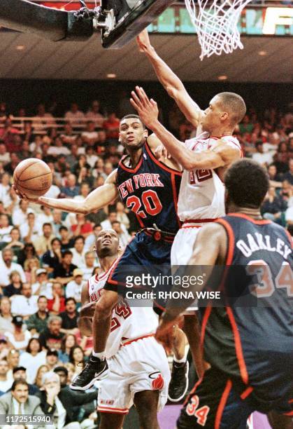Allan Houston of the New York Knicks, who was the top scorer for his team with 30 points, goes up in an offensive effort against P.J. Brown and Jamal...