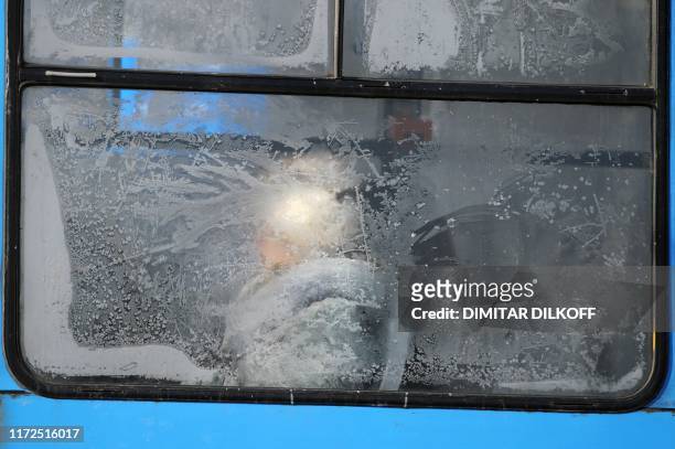 Woman is seen through an icy window on a tram in central Sofia on February 1, 2012. Two more people have died in Bulgaria amid a cold snap that has...
