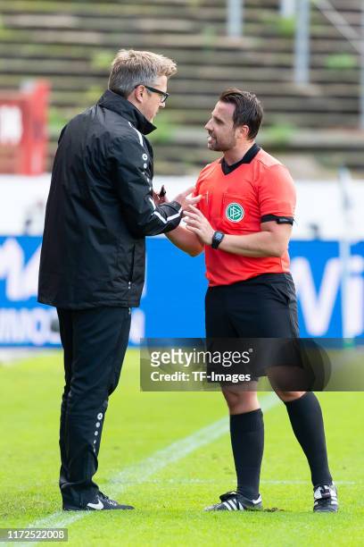 Head coach Sven Huebscher of Preussen Muenster and referee Johann Pfeifer gestures during the 3. Liga match between Preussen Muenster and Bayern...