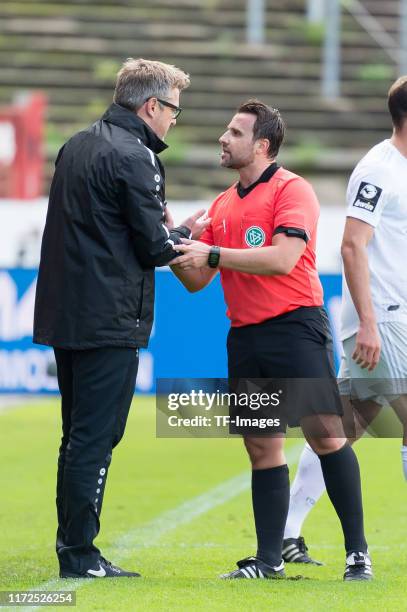 Head coach Sven Huebscher of Preussen Muenster and referee Johann Pfeifer gestures during the 3. Liga match between Preussen Muenster and Bayern...