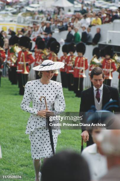 Diana, Princess of Wales and Prince Charles at the Epsom Derby, UK, June 1986. Diana is wearing a black and white spotted dress by Victor Edelstein.