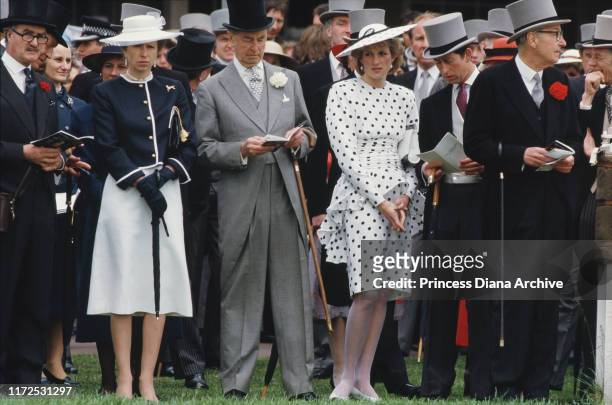 Diana, Princess of Wales and Prince Charles with Princess Anne at the Epsom Derby, UK, June 1986. Diana is wearing a black and white spotted dress by...