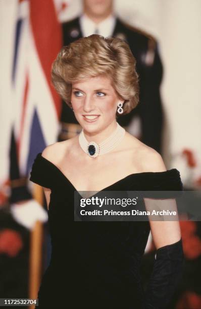 Diana, Princess of Wales wearing a black evening gown by Victor Edelstein during a ball hosted by Ronald and Nancy Reagan at the White House in...