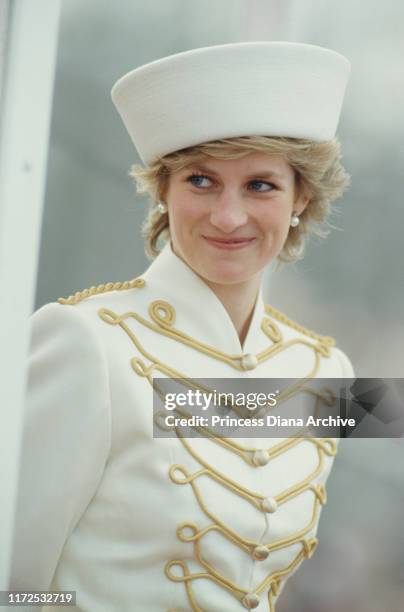 Diana, Princess of Wales visits the Royal Military Academy Sandhurst in Berkshire, UK, wearing a white military-style Catherine Walker suit and a...
