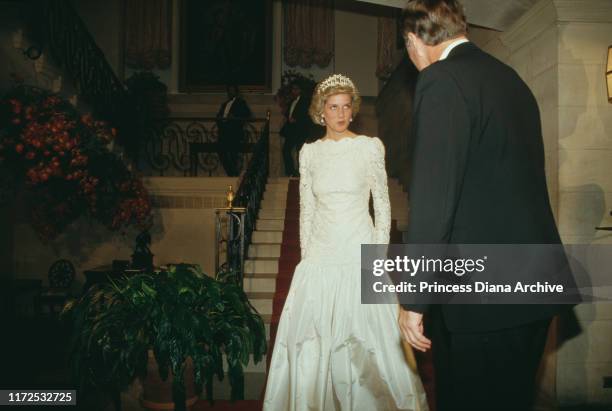 Diana, Princess of Wales attends a dinner at the British Embassy in Washington, DC, November 1985. She is wearing an evening dress by Murray Arbeid...