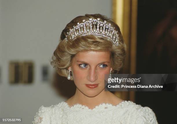 Diana, Princess of Wales attends a dinner at the British Embassy in Washington, DC, November 1985. She is wearing an evening dress by Murray Arbeid...