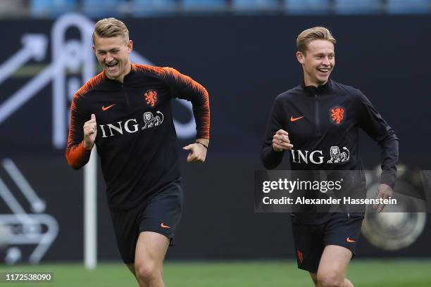 Matthijs de Ligt of Holland smiles with his team mate Frenkie de Jong during a training session of the Netherlands national team prior to the UEFA...