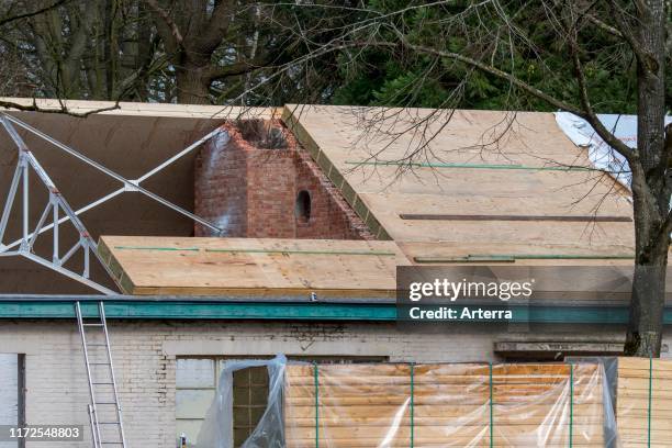 Building fitted with warm pitched roof insulation by installing insulating sandwich panels.