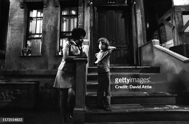 Actress Loretta Long talks to the photographer's son, Oliver Attie, during a break in the taping of an episode of Sesame Street at Reeves TeleTape...