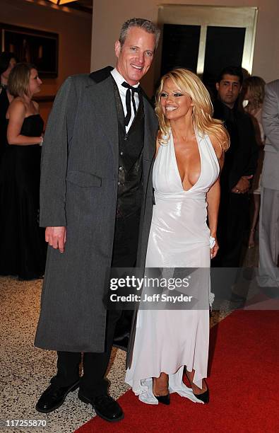 Actress Pamela Anderson and Dan Mathews of PETA arrive at the White House Correspondents' Association Washington Hilton Hotel April 26, 2008 in...