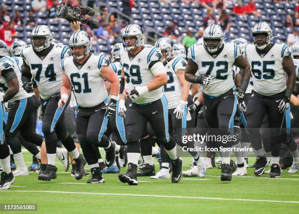 Carolina Panthers offensive tackle Greg Little , Carolina Panthers center Matt Paradis and Carolina Panthers offensive tackle Dennis Daley warm up...