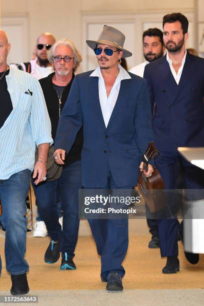 Johnny Depp and Andrea Iervolino are seen arriving at the 76th Venice Film Festival on September 05, 2019 in Venice, Italy.