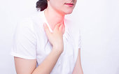 Young caucasian girl on a white background whose pain and inflammation in the throat concept of pharyngitis and laryngti throat diseases, infectious diseases