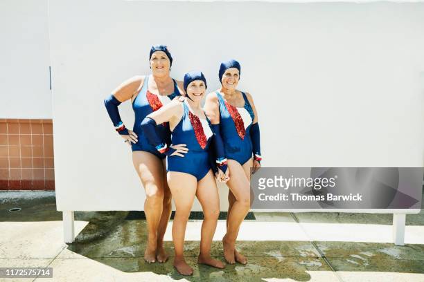 Portrait of smiling senior female synchronized swim team