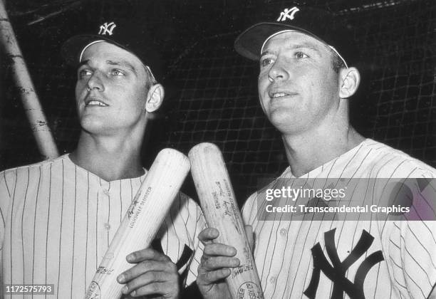Portrait of American baseball players Roger Maris and Mickey Mantle , both of the New York Yankees, as they pose together before a game at Yankee...