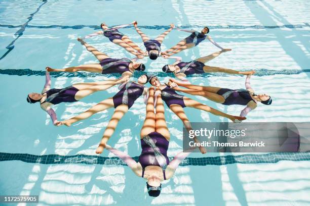 overhead view of senior female synchronized swim team in formation during routine - community strength stock pictures, royalty-free photos & images