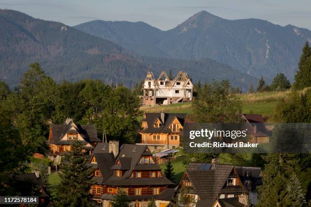 An aerial landscape of new housing that is overlooked by the Tatra mountains in the Polish town of Koscielisko, on 16th September 2019, near...