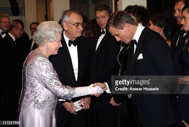 Queen Elizabeth II shakes hands with British actor Daniel Craig the new James Bond at the Royal Premiere for the 21st Bond film 'Casino Royale' at...