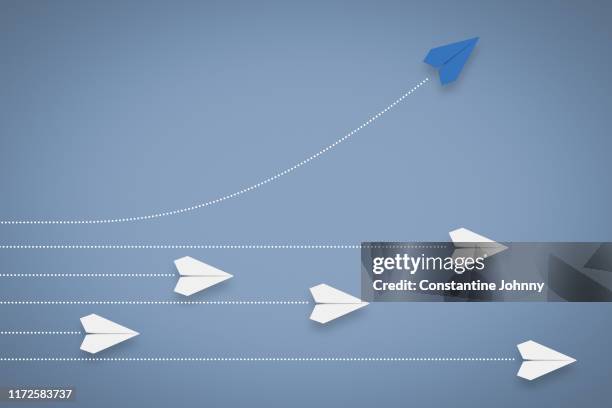 paper airplane different direction and approach. think different & leadership concept. - growth concept stockfoto's en -beelden