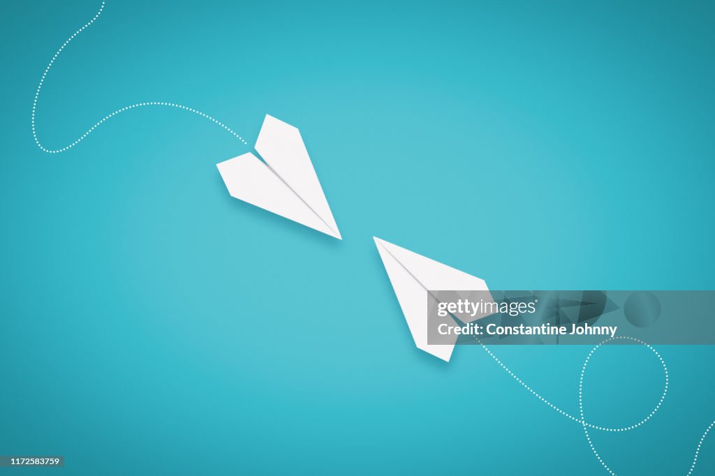 Two Paper Airplanes Facing Each Other