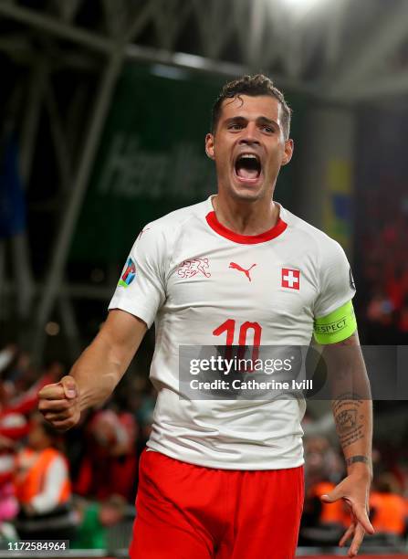 Granit Xhaka of Switzerland celebrates the goal of Fabian Schar during the UEFA Euro 2020 qualifier between Republic of Ireland and Switzerland at...