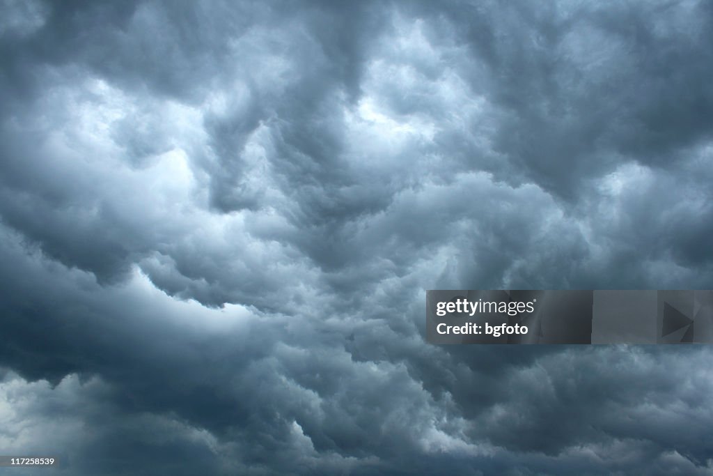 Swirling, threatening gray storm clouds filling sky