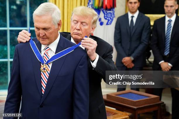 President Donald Trump gives the Presidential Medal of Freedom to National Basket Ball Hall of Fame inductee Jerry West during a ceremony in the Oval...