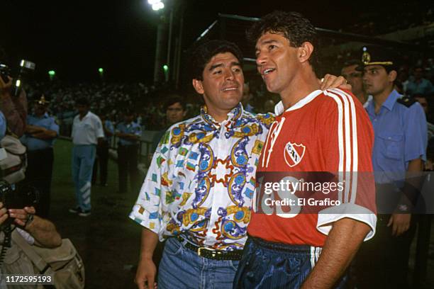 Diego Maradona head coach of Racing Club greets Jorge Burruchaga of Independiente during a friendly match between Racing club and Independiente on...