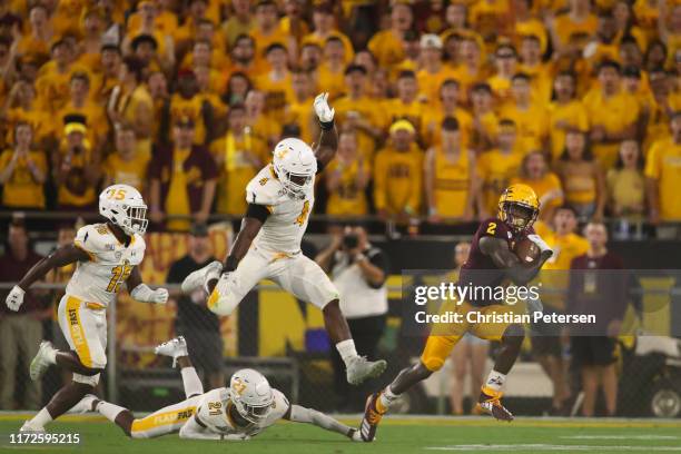 Wide receiver Brandon Aiyuk of the Arizona State Sun Devils runs with the football ahead of linebacker Cepeda Phillips and cornerback Keith Sherald...