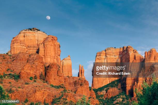 a full moon rises above cathedral rock in sedona - sightseeing in sedona stock pictures, royalty-free photos & images