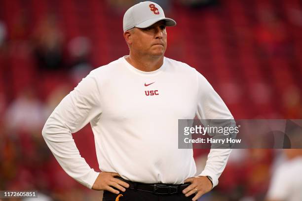 Head coach Clay Helton of the USC Trojans watches warm up before the game against the Fresno State Bulldogs at Los Angeles Memorial Coliseum on...