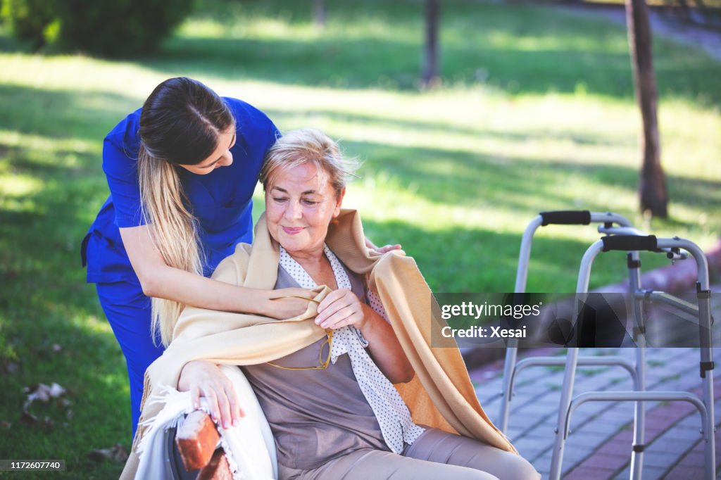 Nurse helping old woman for comfort and care