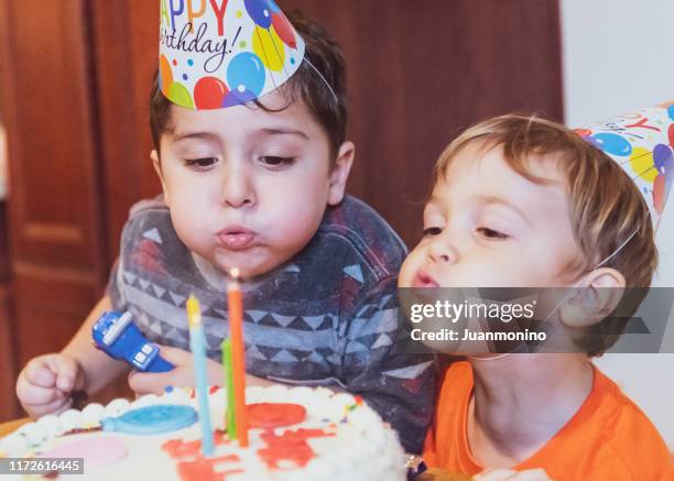 vintage image from the seventies, children blowing birthday cake candles - vintage birthday imagens e fotografias de stock