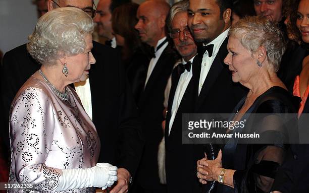 Queen Elizabeth II meets Dame Judi Dench at the Royal Premiere for the 21st Bond film Casino Royale at the Odeon, Leicester Square on November 14,...