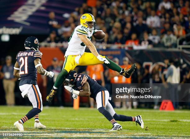Jimmy Graham of the Green Bay Packers leaps over Eddie Jackson of the Chicago Bears during the first half at Soldier Field on September 05, 2019 in...