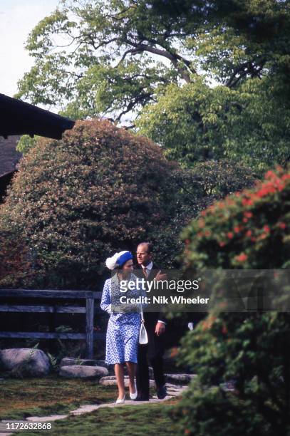 Her Majesty Queen Elizabeth II and her husband Prince Philip walk in garden of temple in Kyoto during the Royal Tour of Japan in May 1975