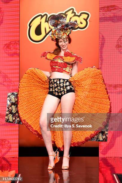 Model walks the runway wearing fashion by Award-winning Costume Designer Ami Goodheart as Cheetos unveiled fan-inspired versions of the...
