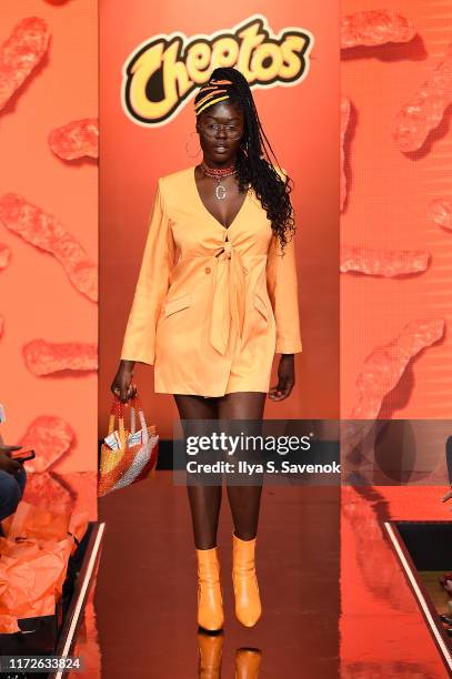 Model walks the runway as Cheetos unveiled fan-inspired versions of the #CheetosFlaminHaute look at The House Of Flamin' Haute Runway Show + Style...