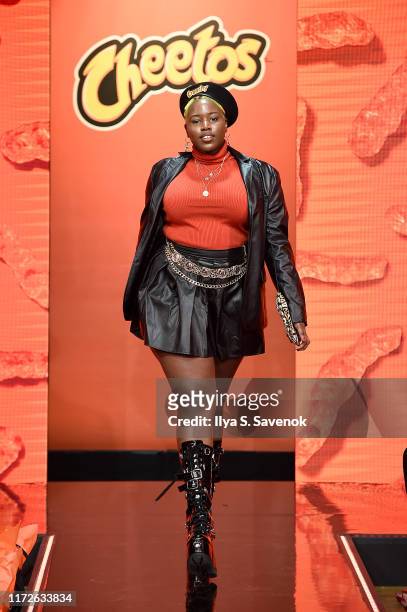 Model walks the runway as Cheetos unveiled fan-inspired versions of the #CheetosFlaminHaute look at The House Of Flamin' Haute Runway Show + Style...