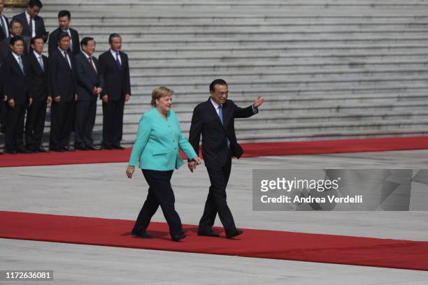Chinese Premier Li Keqiang show the way to the place where they will listen to the national anthems to Chancellor of Germany Angela Merkel at The...