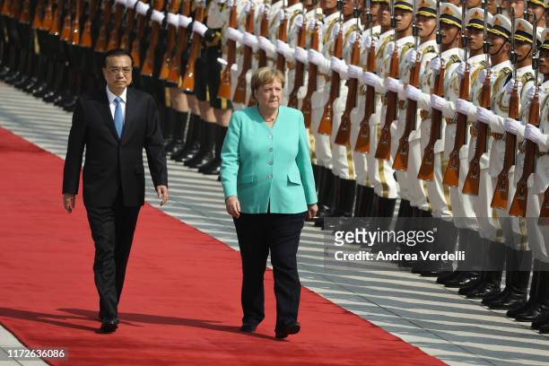 Chinese Premier Li Keqiang and Chancellor of Germany Angela Merkel review the Guard of Honour of the People's Liberation Army at The Great Hall Of...