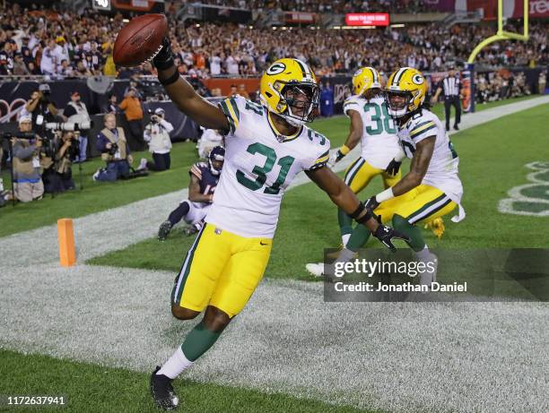 Adrian Amos of the Green Bay Packers celebrates afterintercepting a pass in the end zone over Allen Robinson of the Chicago Bears at Soldier Field on...