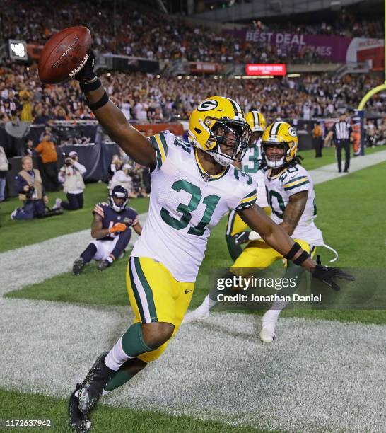 Adrian Amos of the Green Bay Packers celebrates afterintercepting a pass in the end zone over Allen Robinson of the Chicago Bears at Soldier Field on...