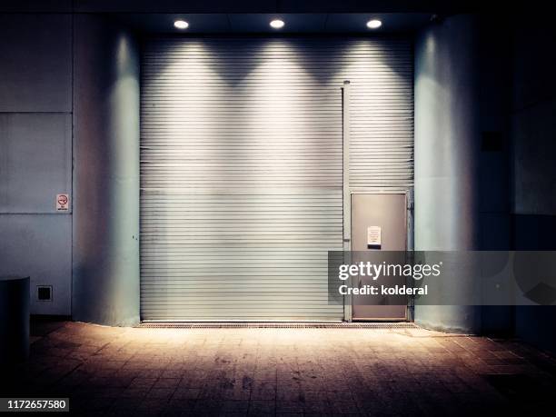 closed rolling doors - shop shutter stock pictures, royalty-free photos & images